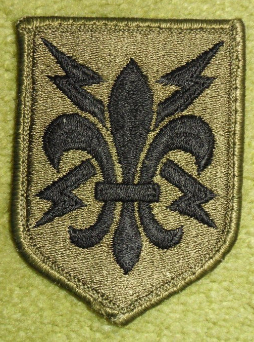 patch with fleur-de-lis centered in front of two crossed silver gray lightning bolts.